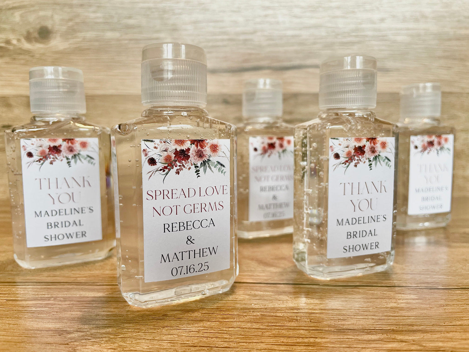 Hand sanitizer wedding favors with personalized tag with pink / terracotta floral design.